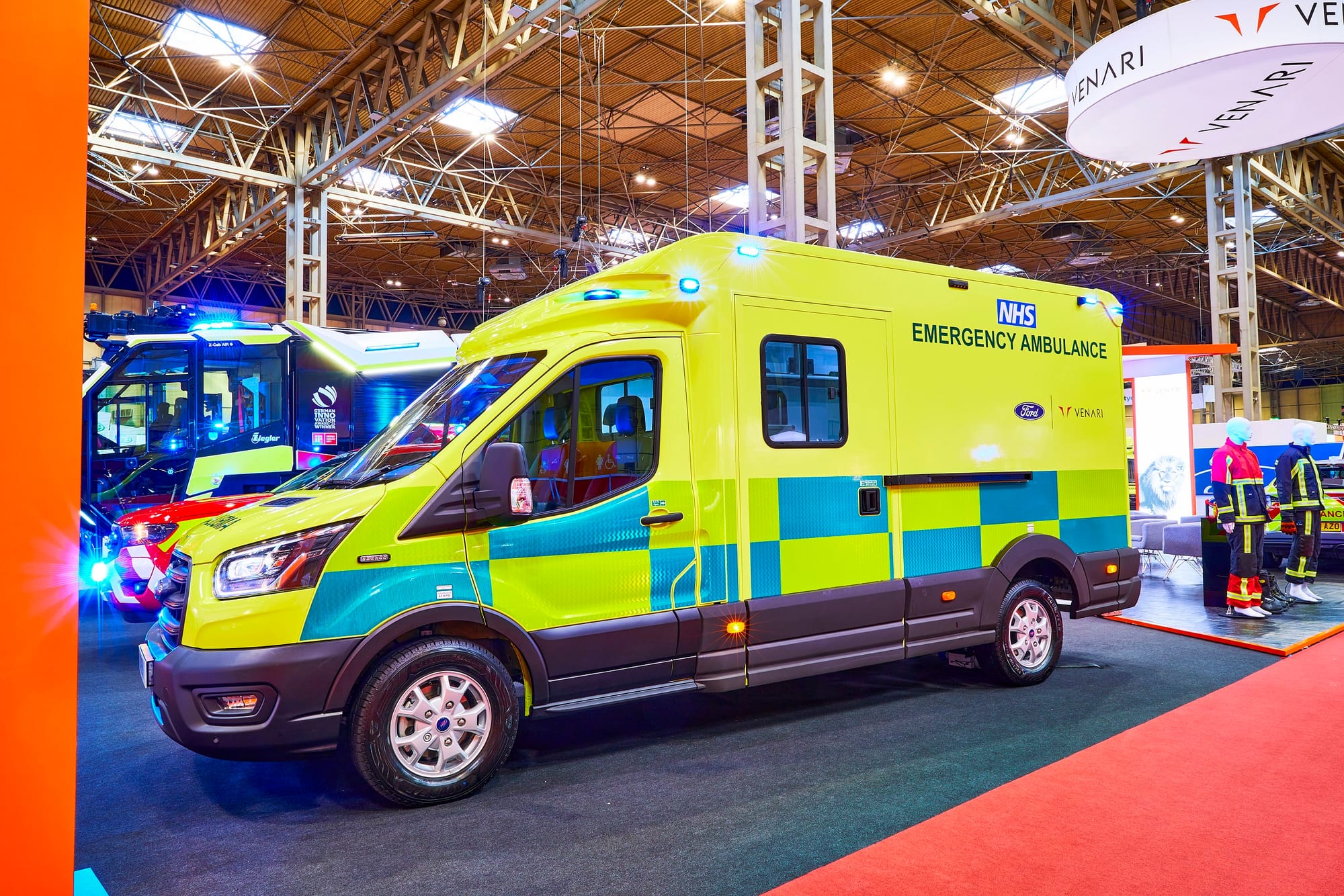 An ambulance pictured indoors at a show/exposition 