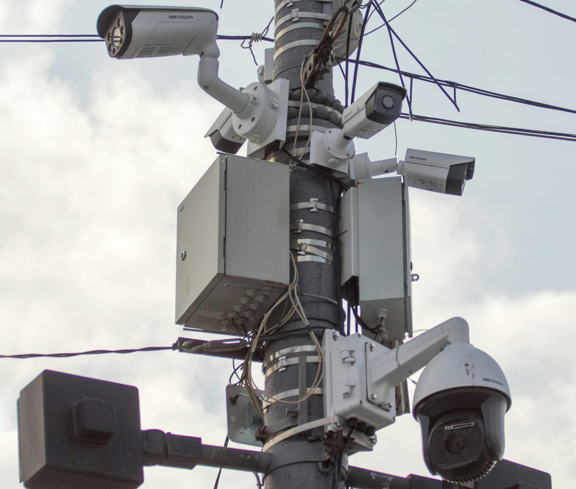 A cluster of surveillance cameras on a pole