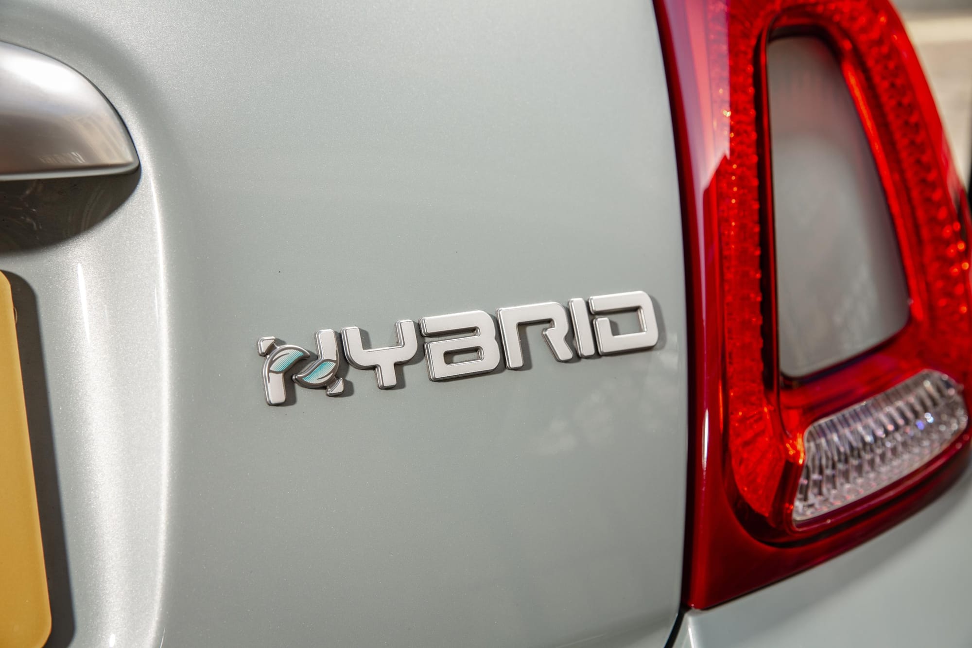 A 'hybrid' logo on the rear of a car