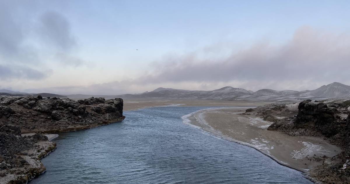 A river in Iceland, with hills seen in the background