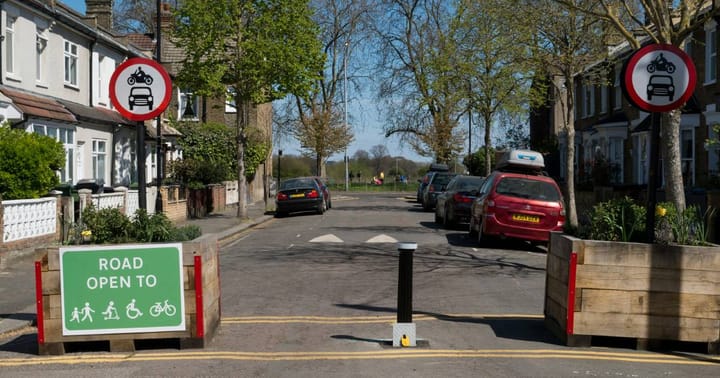 An image of a road closed by low traffic neighbourhood signs, and bollards